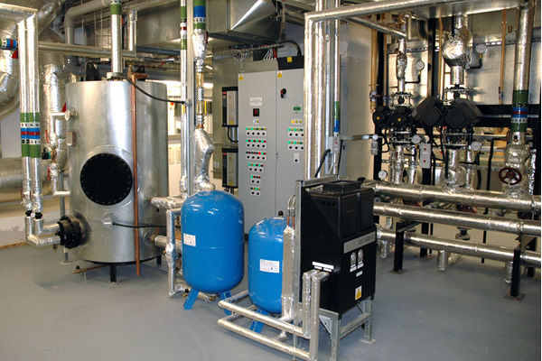 Plant room showing HWS tank and floor standing control panel